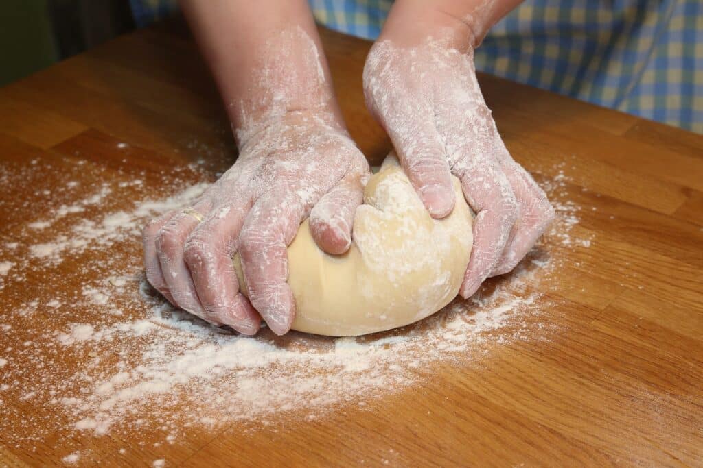 Pizzateig auseinanderziehen so wird es gemacht